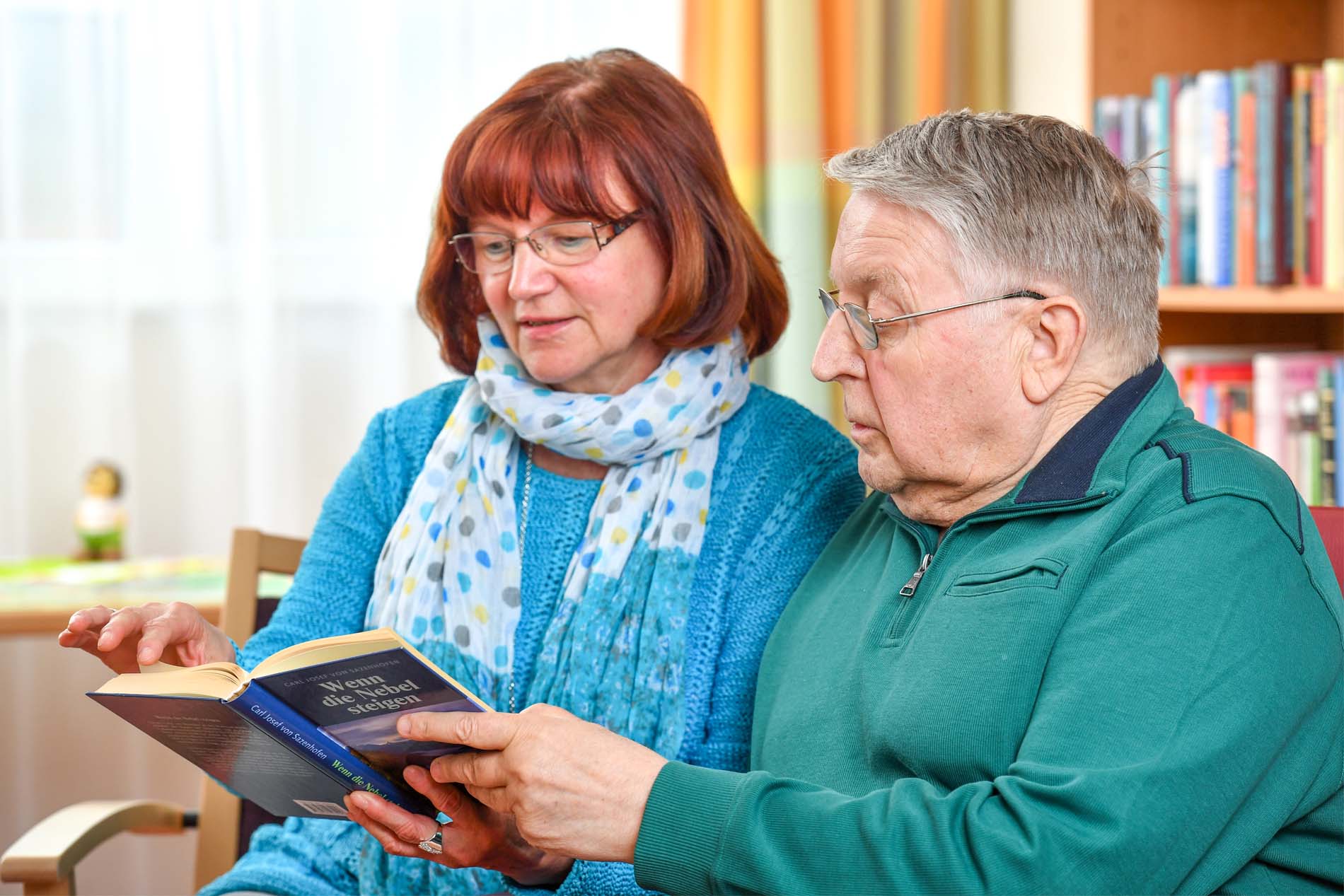 Ehrenamtliche und Bewohner lesen zusammen ein Buch Ehrenamtliche und Bewohner lesen zusammen ein Buch