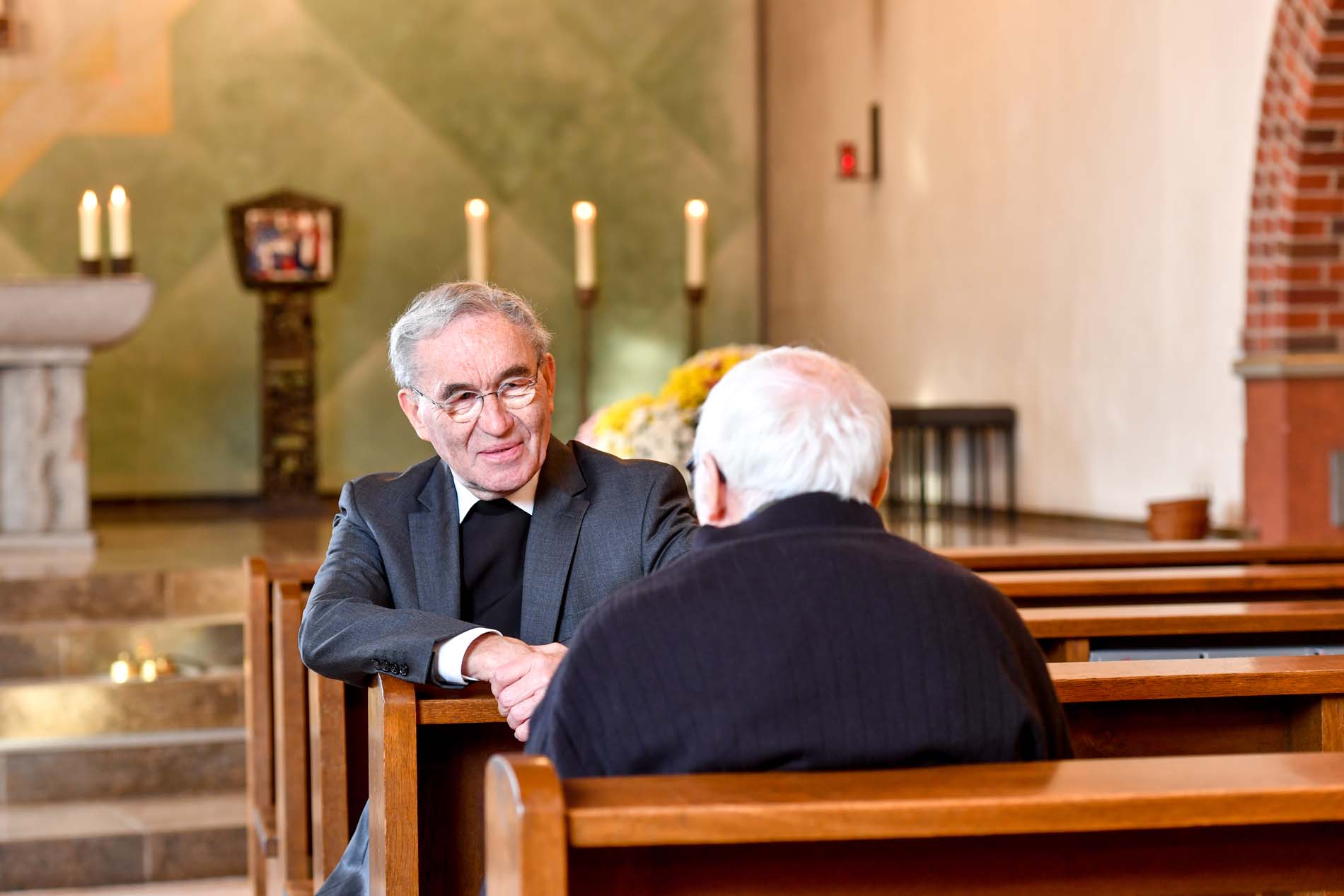 Seelsorger im vertrauten Gespräch mit dem Bewohner in der Kapelle 